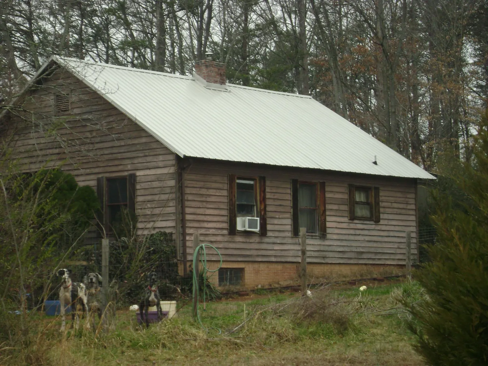 White metal roof on an old wood sided farmhouse, from a Metal Roof Installation job in Hayes